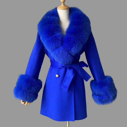 Blue coat with fur accents on a mannequin against a plain background