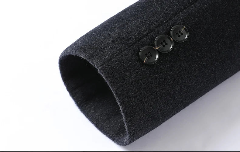 Close-up of dark gray cuff with buttons on a white background