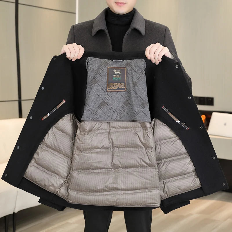 Person holding a black coat with quilted gray lining
