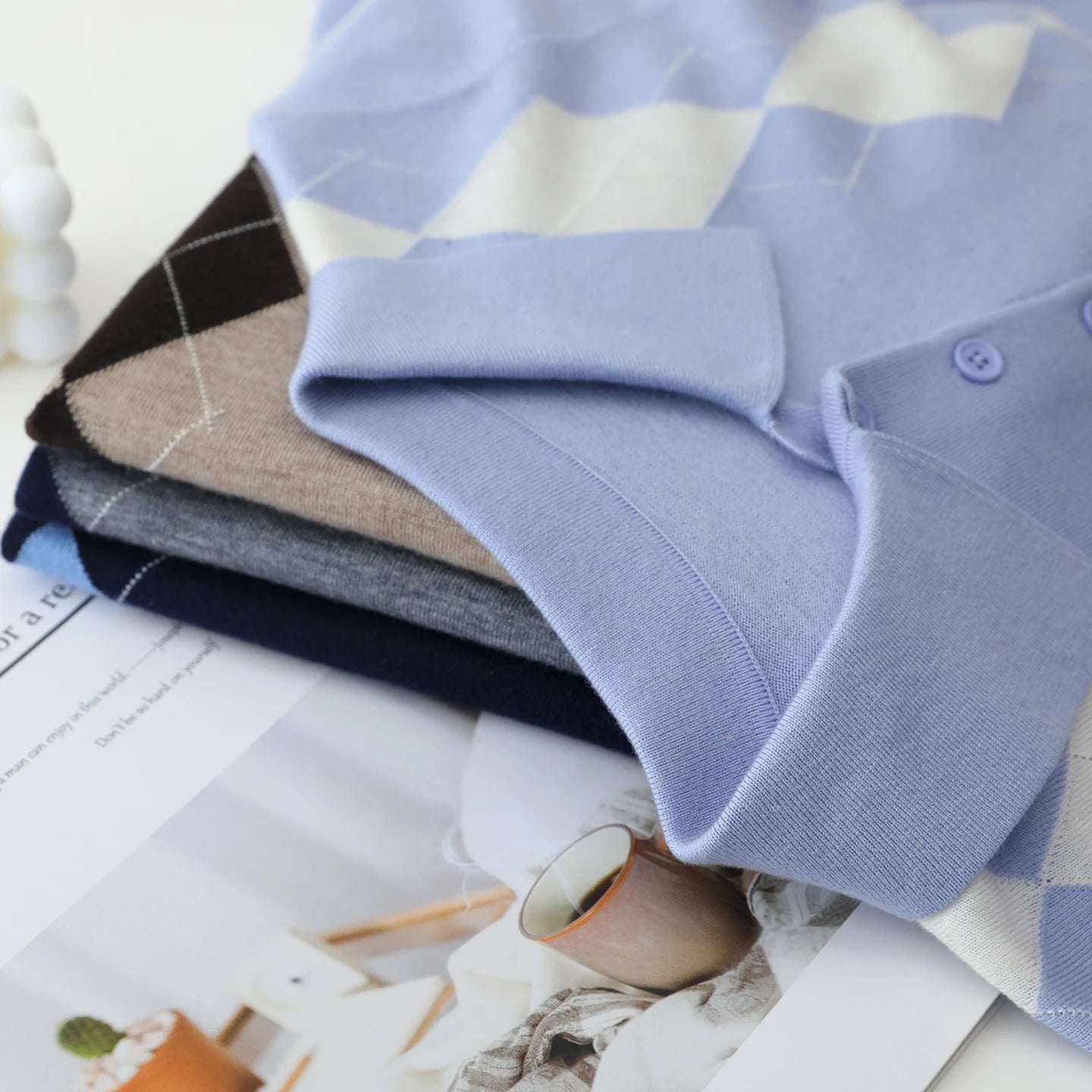 Stack of folded shirts on a checkered fabric background