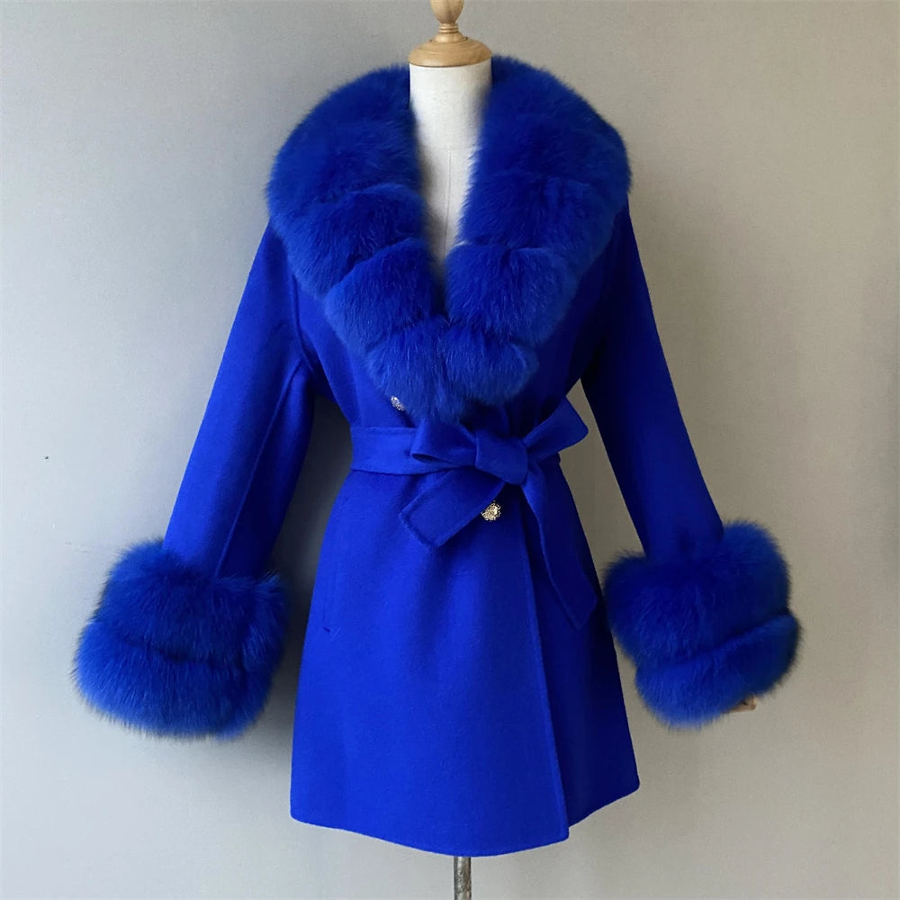 Blue coat with fur trim on a mannequin against a plain background