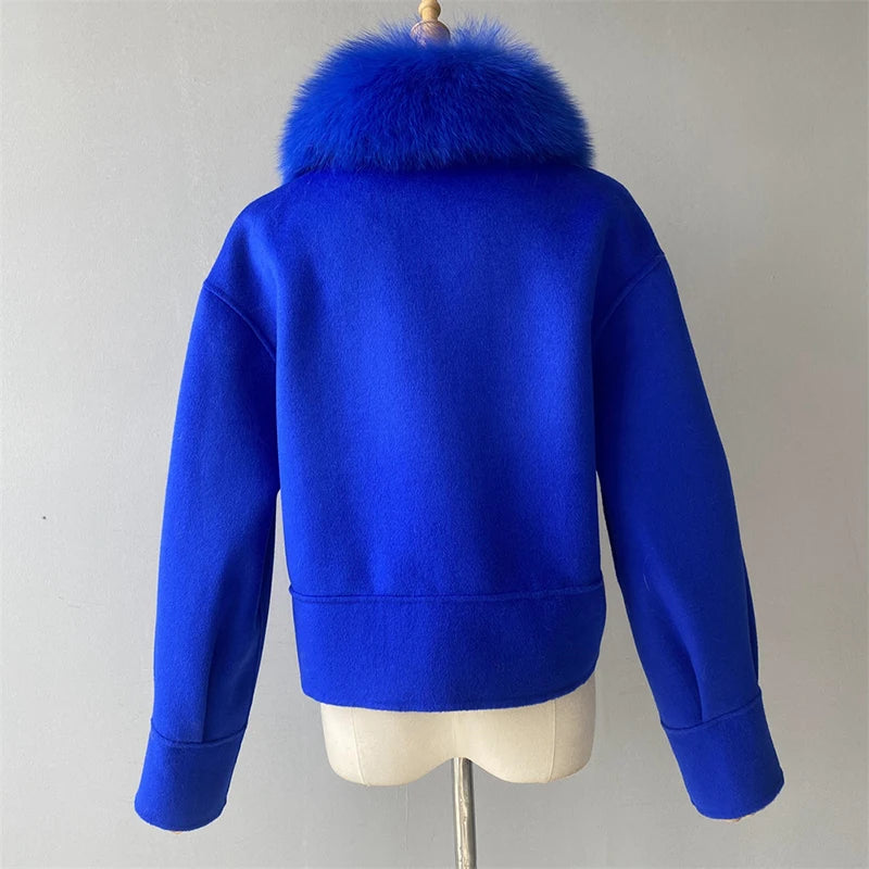 Blue jacket with fur collar on a mannequin against a gray background