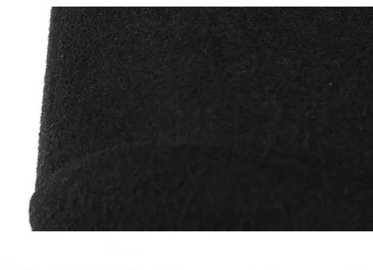 Close-up of black textured fabric with visible stitching