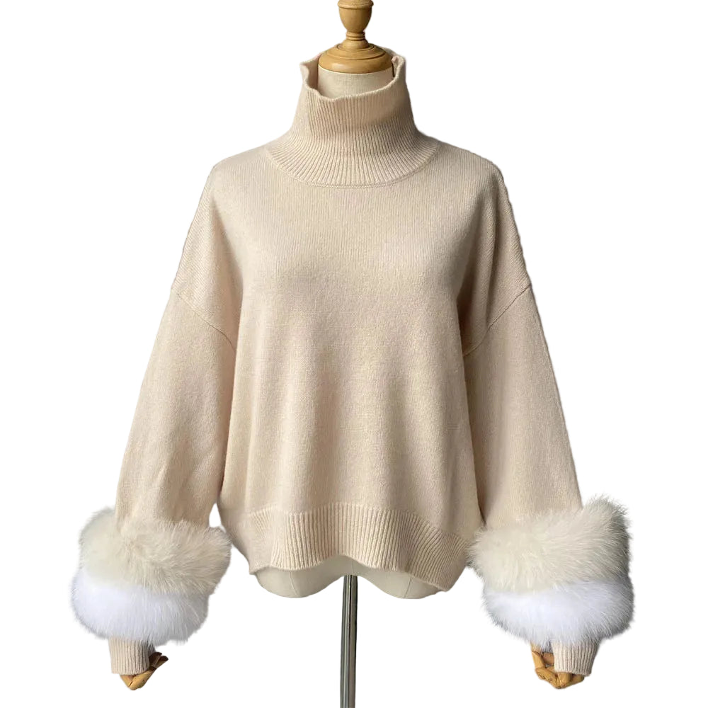 Beige sweater with fur cuffs on a mannequin against a gray background