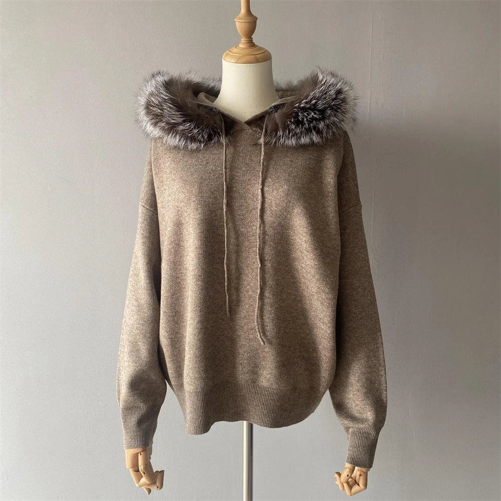 Beige hoodie with fur trim on a mannequin against a plain background