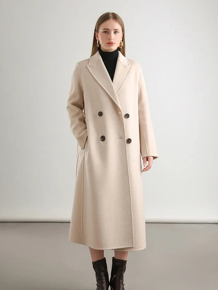 Woman wearing a beige coat against a plain background