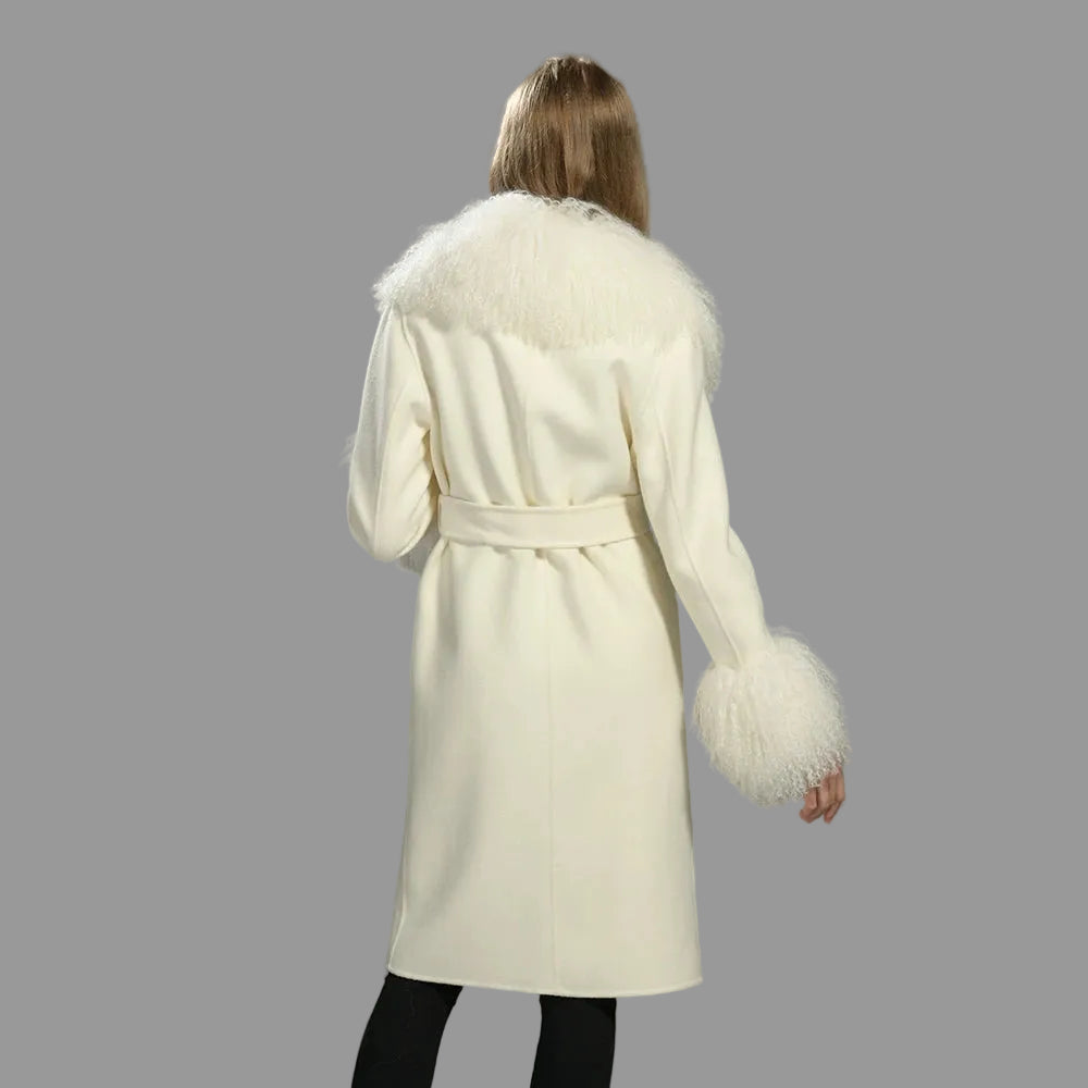 White coat with fur trim worn by a person on a gray background