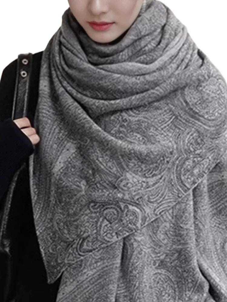 Person wearing a gray patterned scarf on a white background