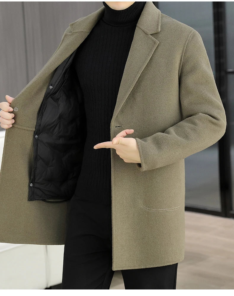Person wearing a green coat over a black outfit with a blurred background