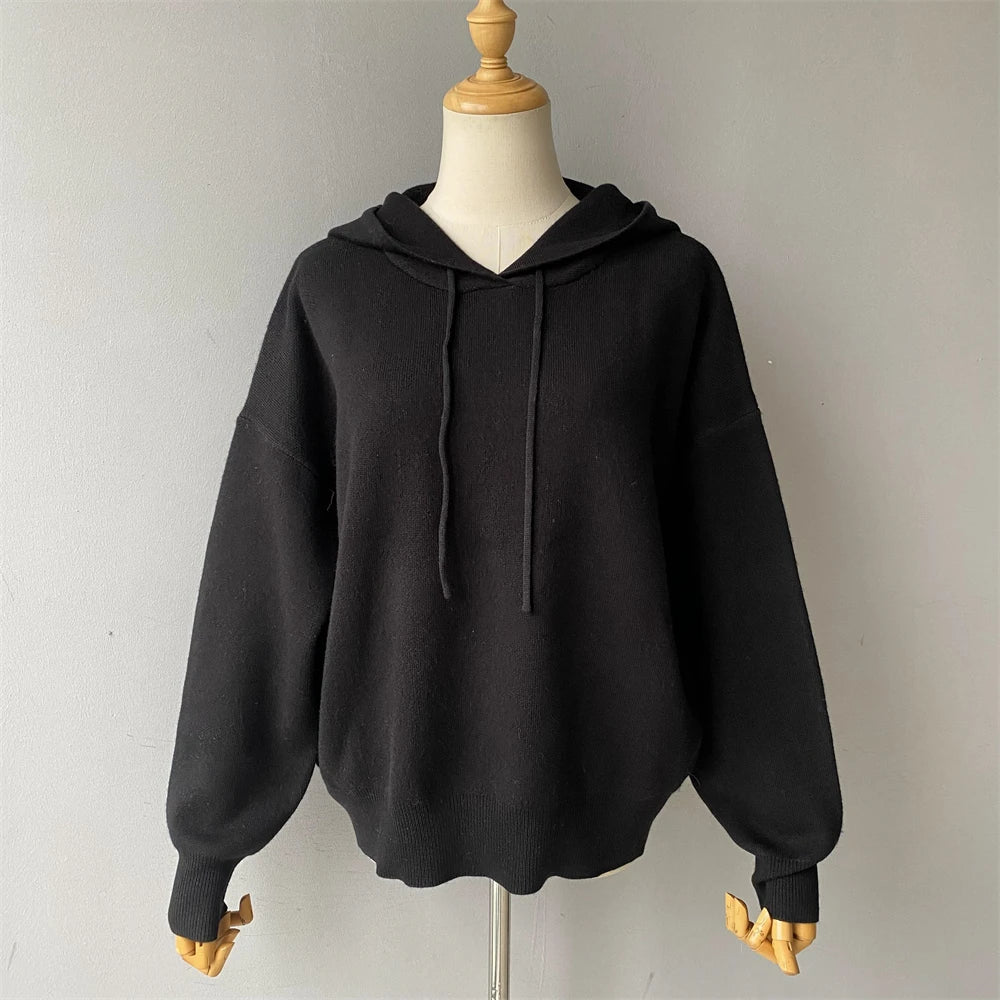 Black hoodie on a mannequin against a plain background