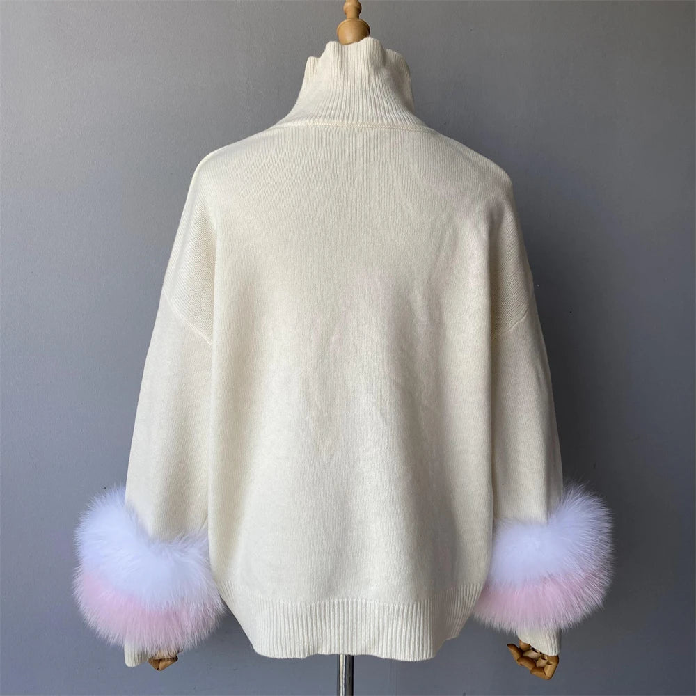 White sweater with fluffy pink cuffs on a mannequin against a gray background