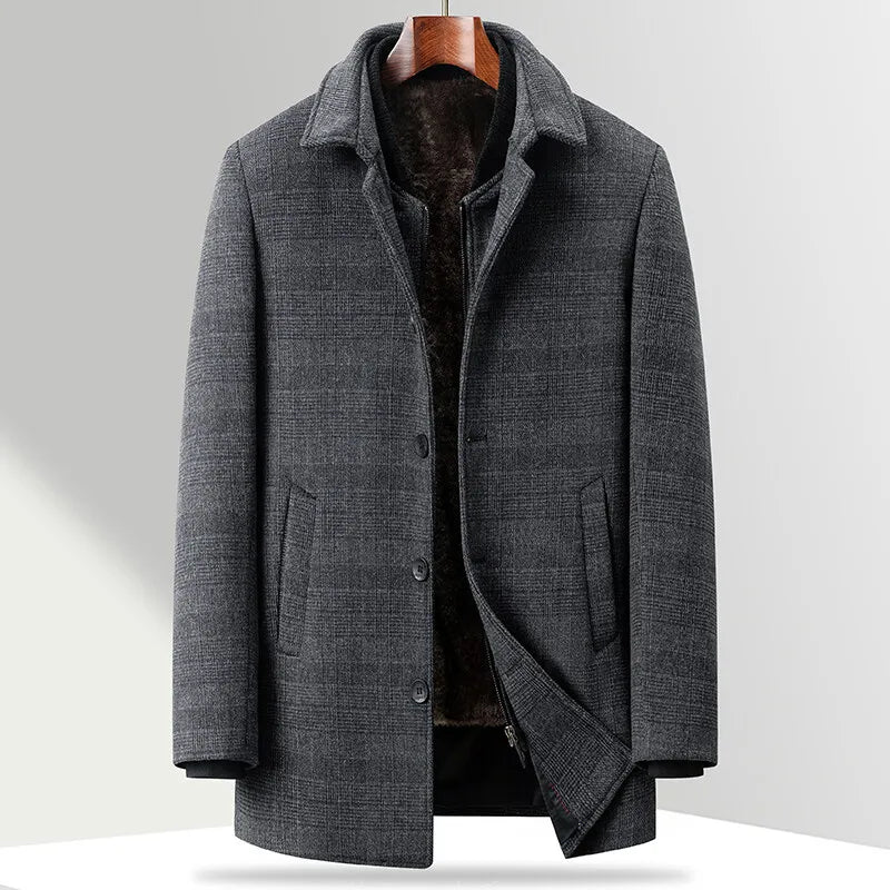 Gray coat on a hanger against a light gray background
