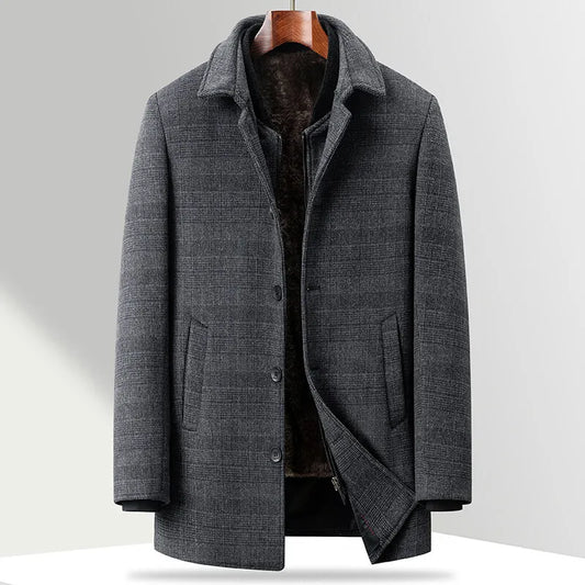 Gray coat on a hanger against a light gray background