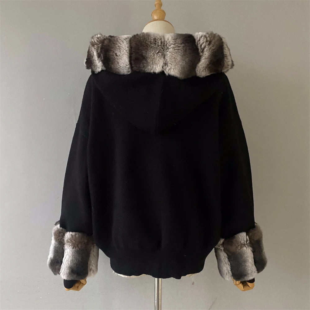 Black hoodie with fur trim on a mannequin against a plain background