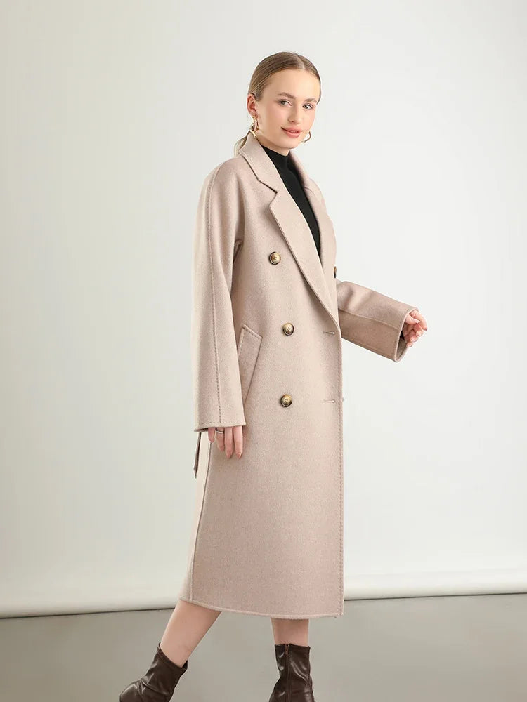 Woman wearing a beige coat on a white background