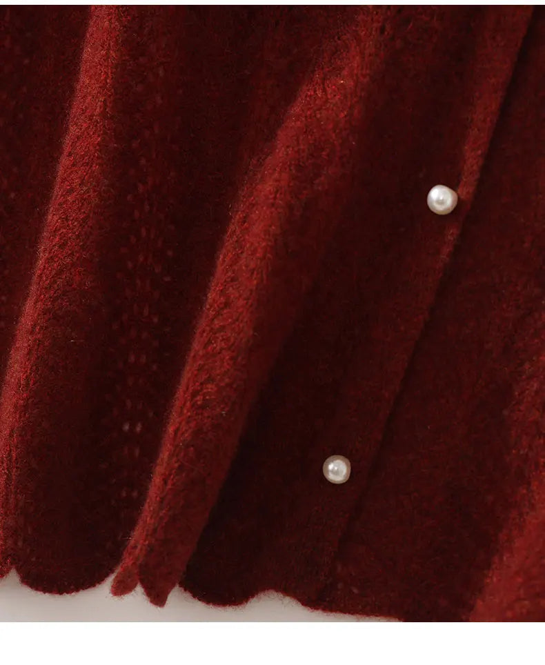 Close-up of a red textured fabric with pearl buttons on a white background