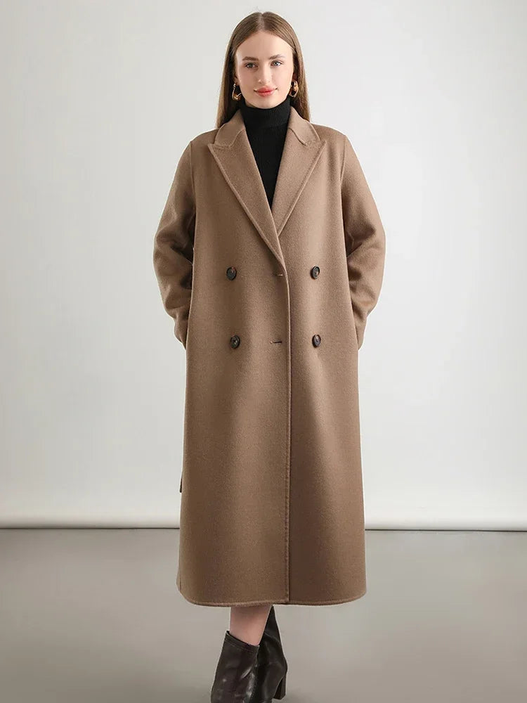 Woman wearing a brown coat against a plain background