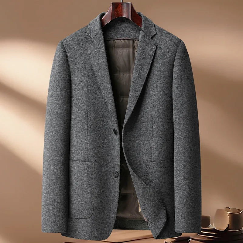 Gray blazer on a hanger against a beige background