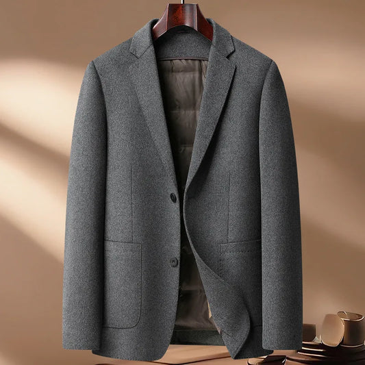 Gray blazer on a hanger against a beige background