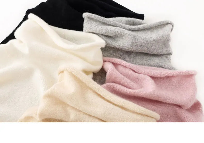 Four folded scarves in black, gray, white, and pink on a white background