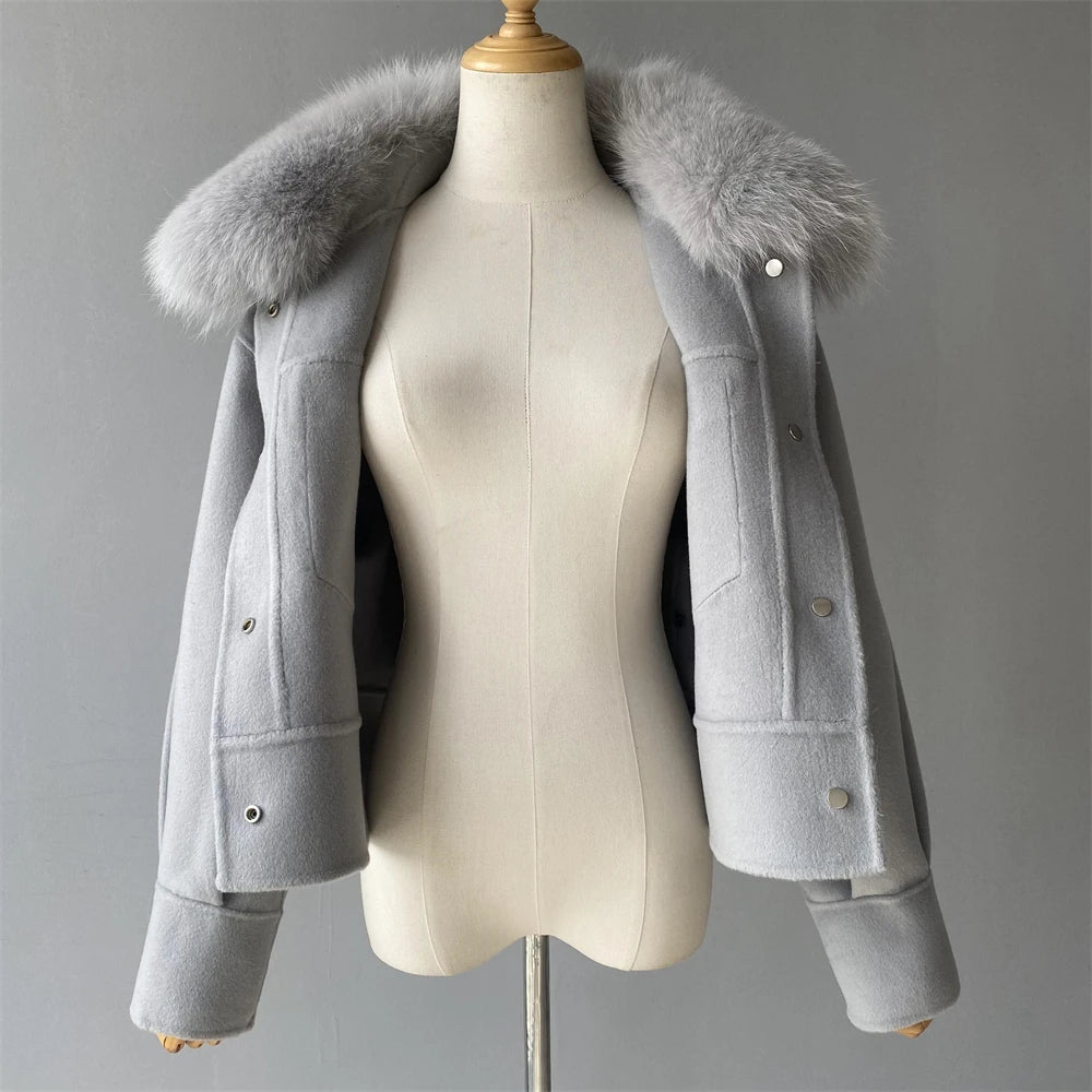 Gray coat with fur collar on a mannequin against a gray background