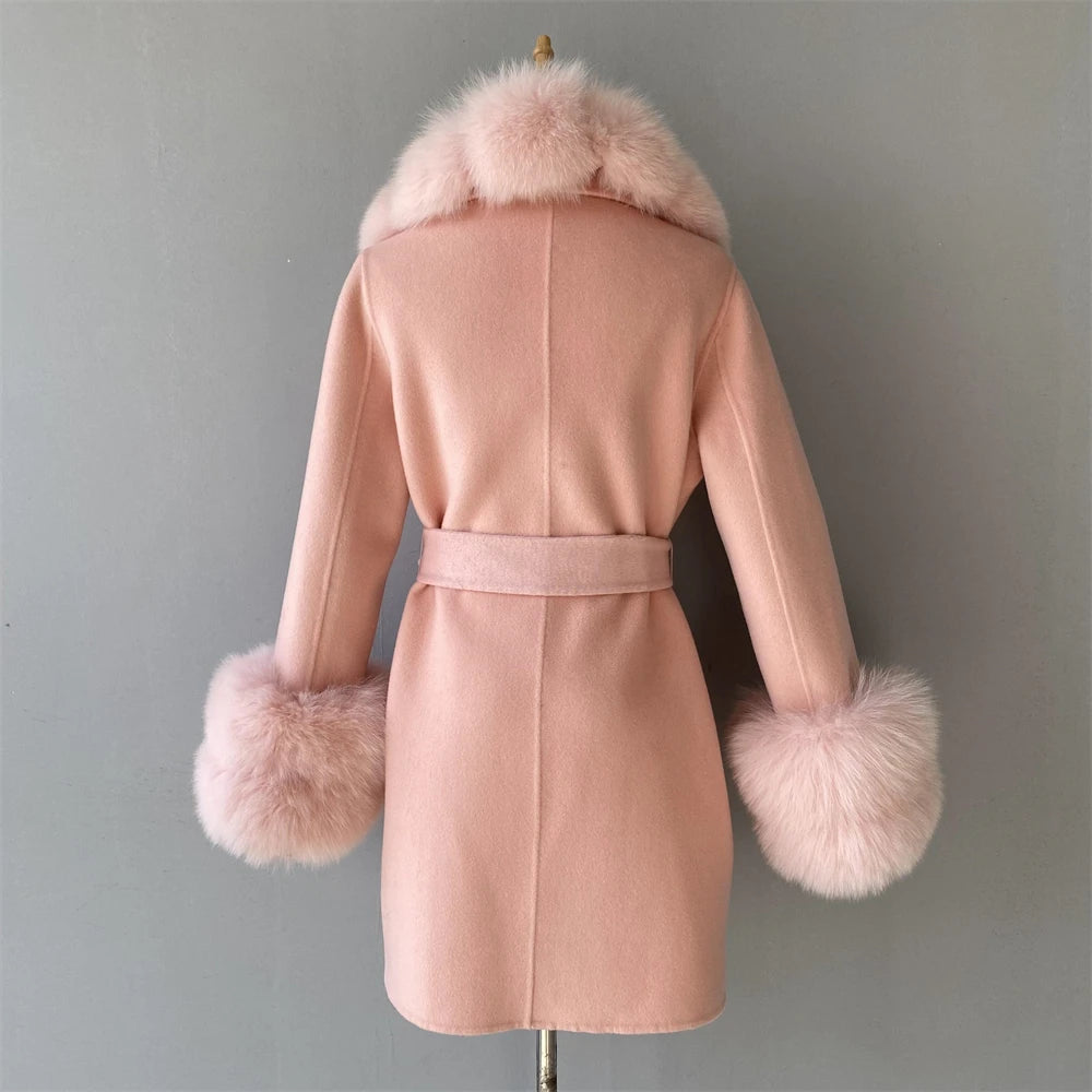 Pink coat with fur trim on a mannequin against a gray background