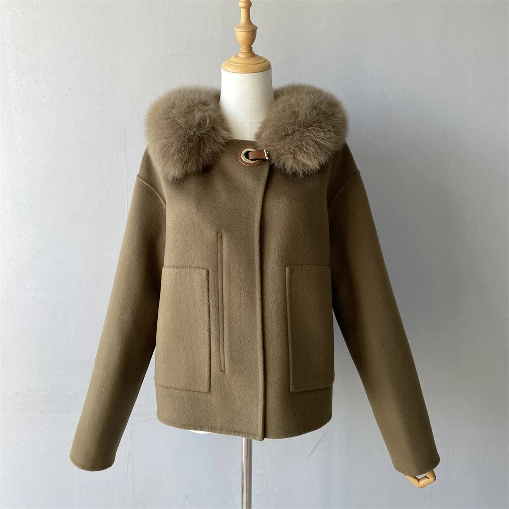 Brown coat with fur collar on a mannequin against a plain background