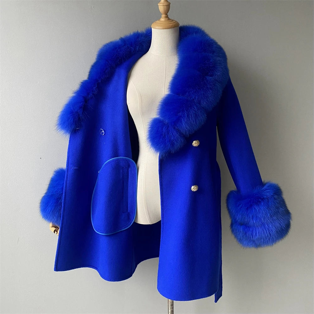 Blue coat with fur trim on a mannequin against a plain background