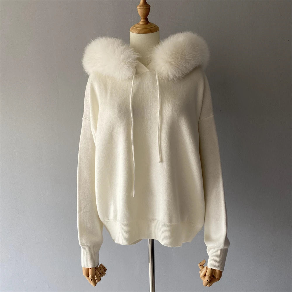 White hoodie with fur hood on a mannequin against a gray background