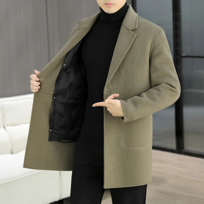 Person wearing a green coat over a black outfit in an indoor setting