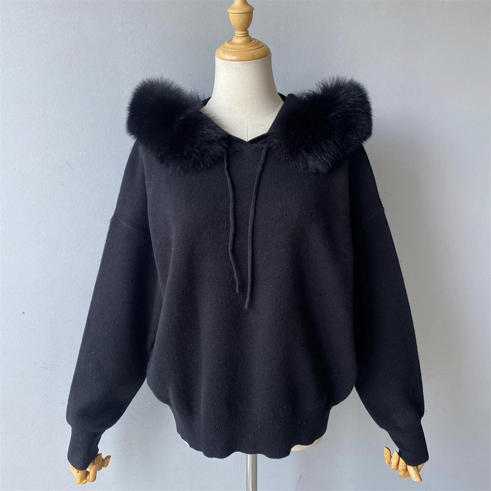 Black hoodie with fur-lined hood on a mannequin against a plain background
