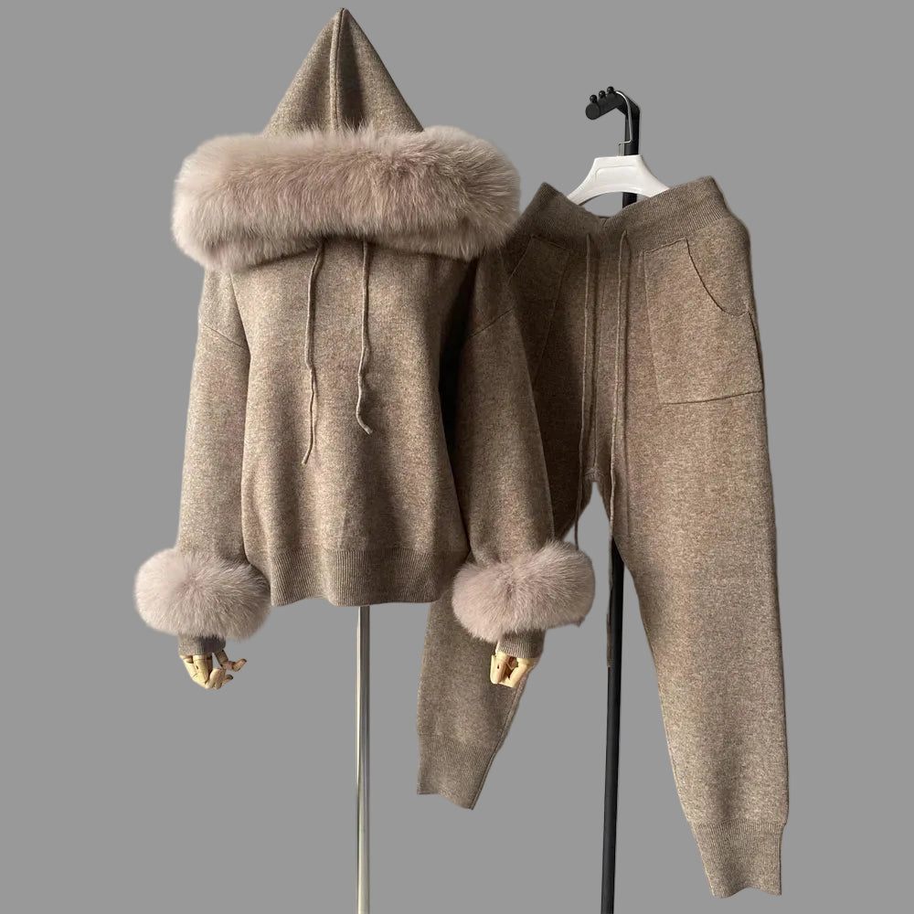 Brown winter outfit with fur details on a hanger against a gray background