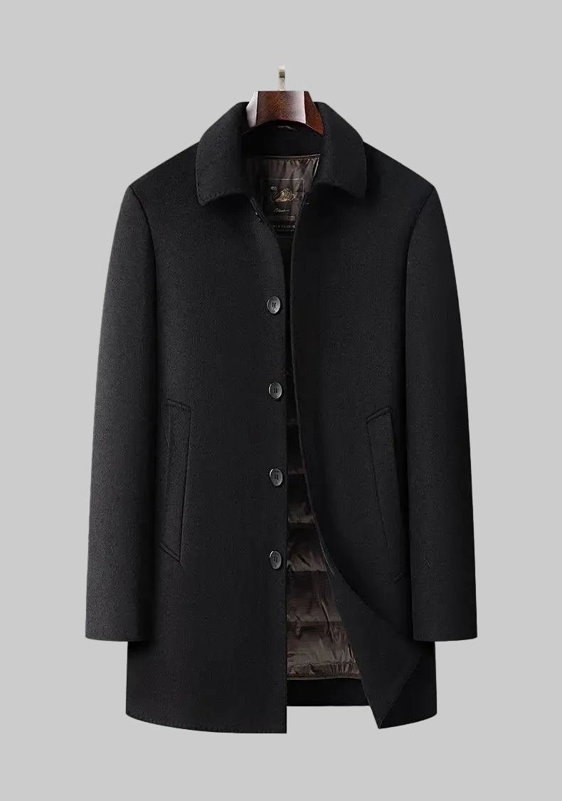 Black coat on a mannequin against a gray background