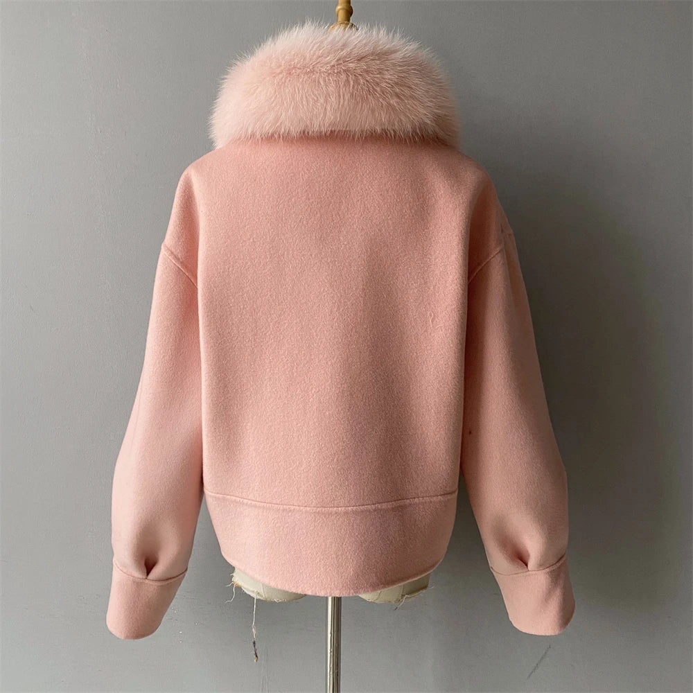 Pink jacket with fur collar on a gray background