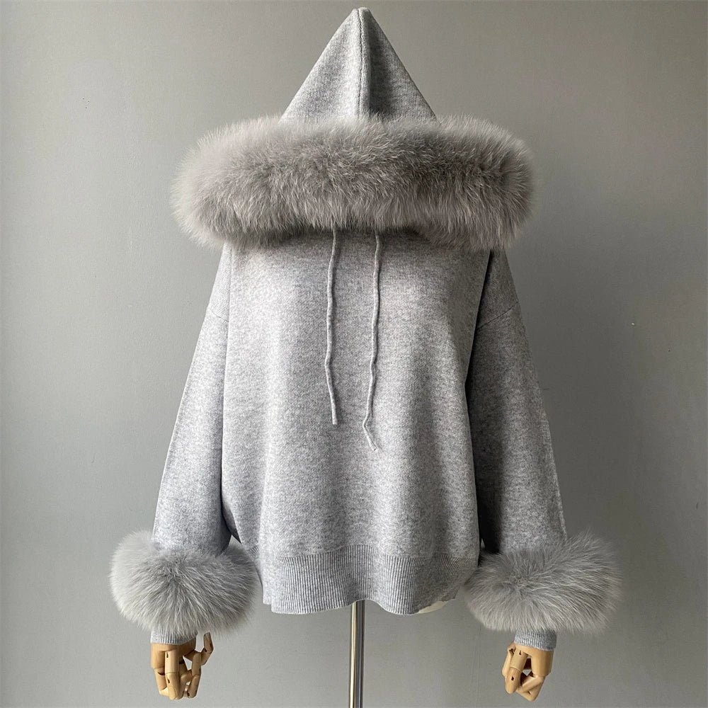Gray hoodie with fur trim on a mannequin against a plain background
