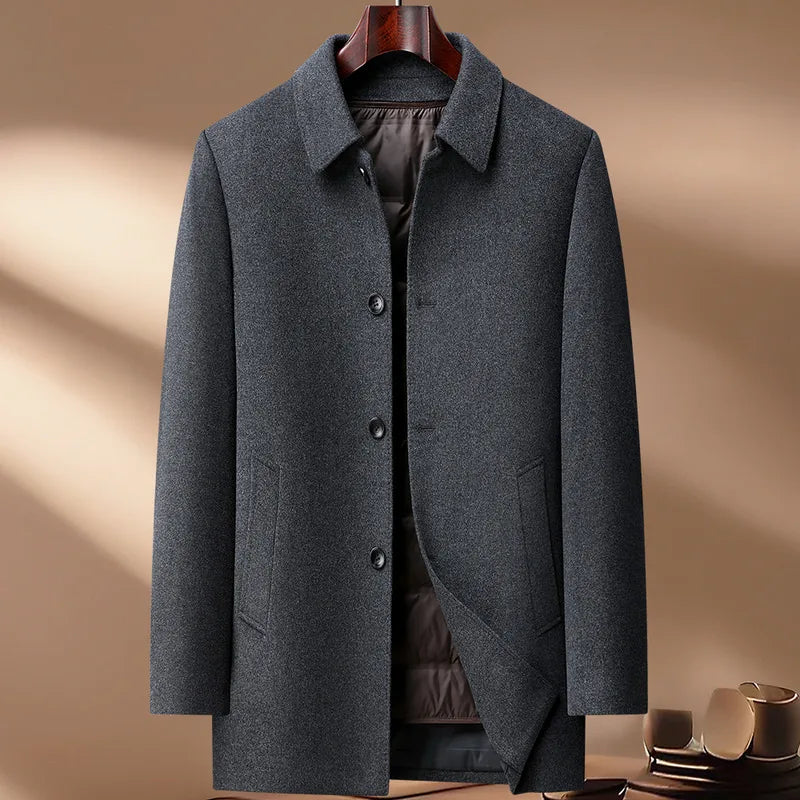 Gray coat on a hanger against a beige background