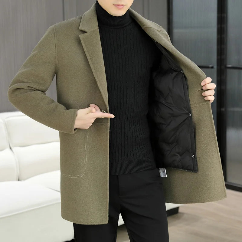 Person wearing a green coat with a black interior, standing indoors.