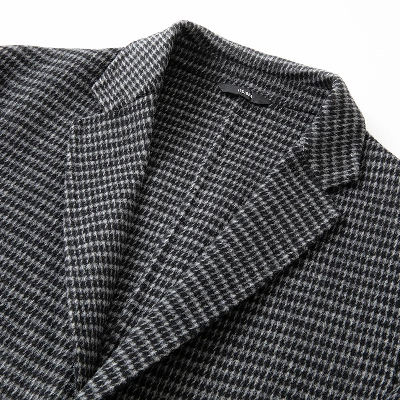 Close-up of a gray houndstooth patterned fabric with a brand label.
