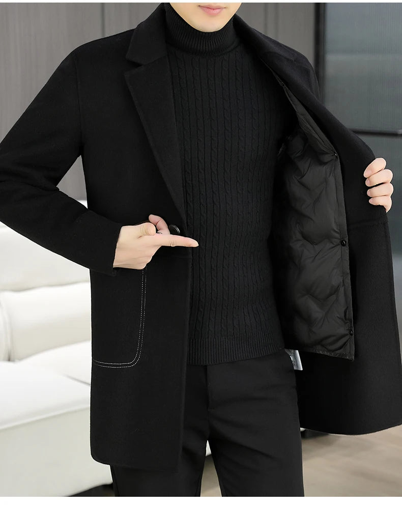 Person wearing a black coat over a black sweater and pants in an indoor setting.