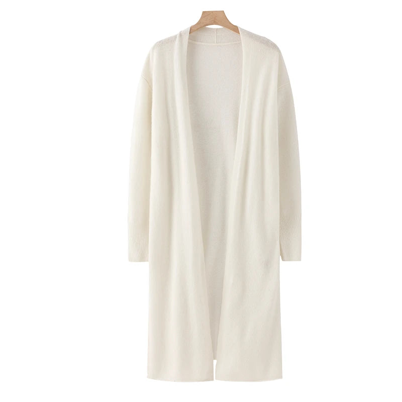 White cardigan on a hanger against a white background