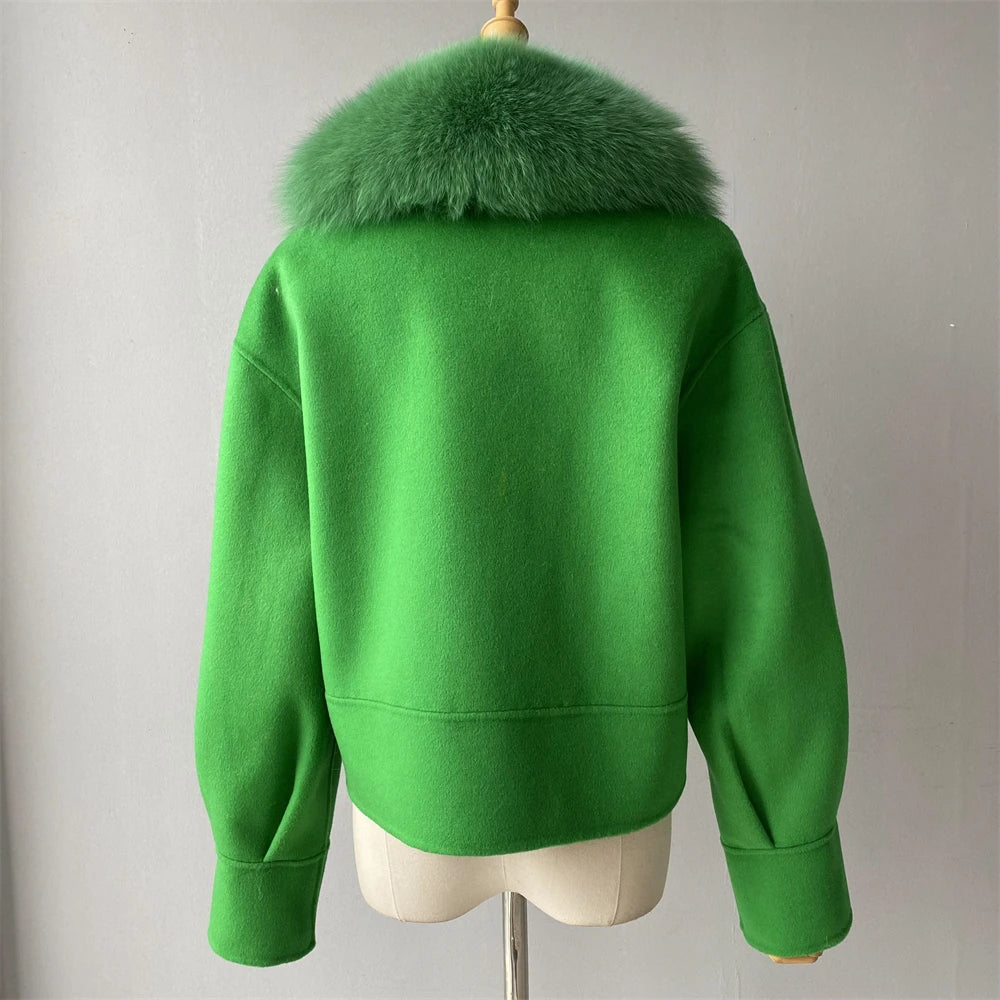 Green jacket with fur collar on a mannequin against a plain background