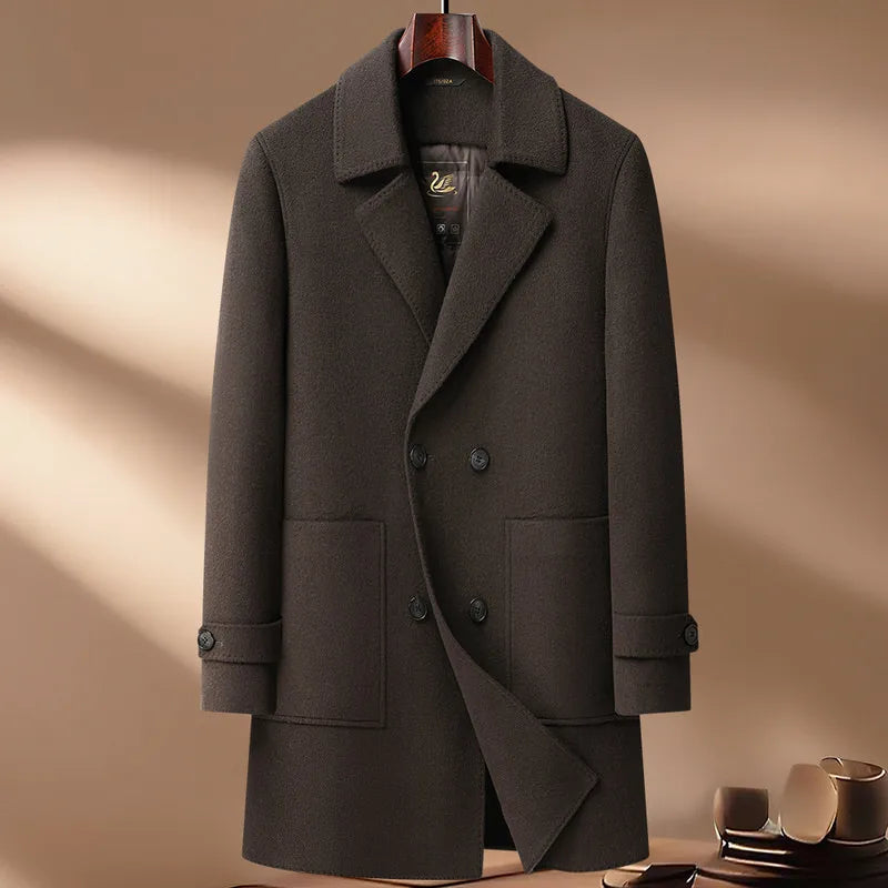 Dark gray coat on a hanger against a beige background