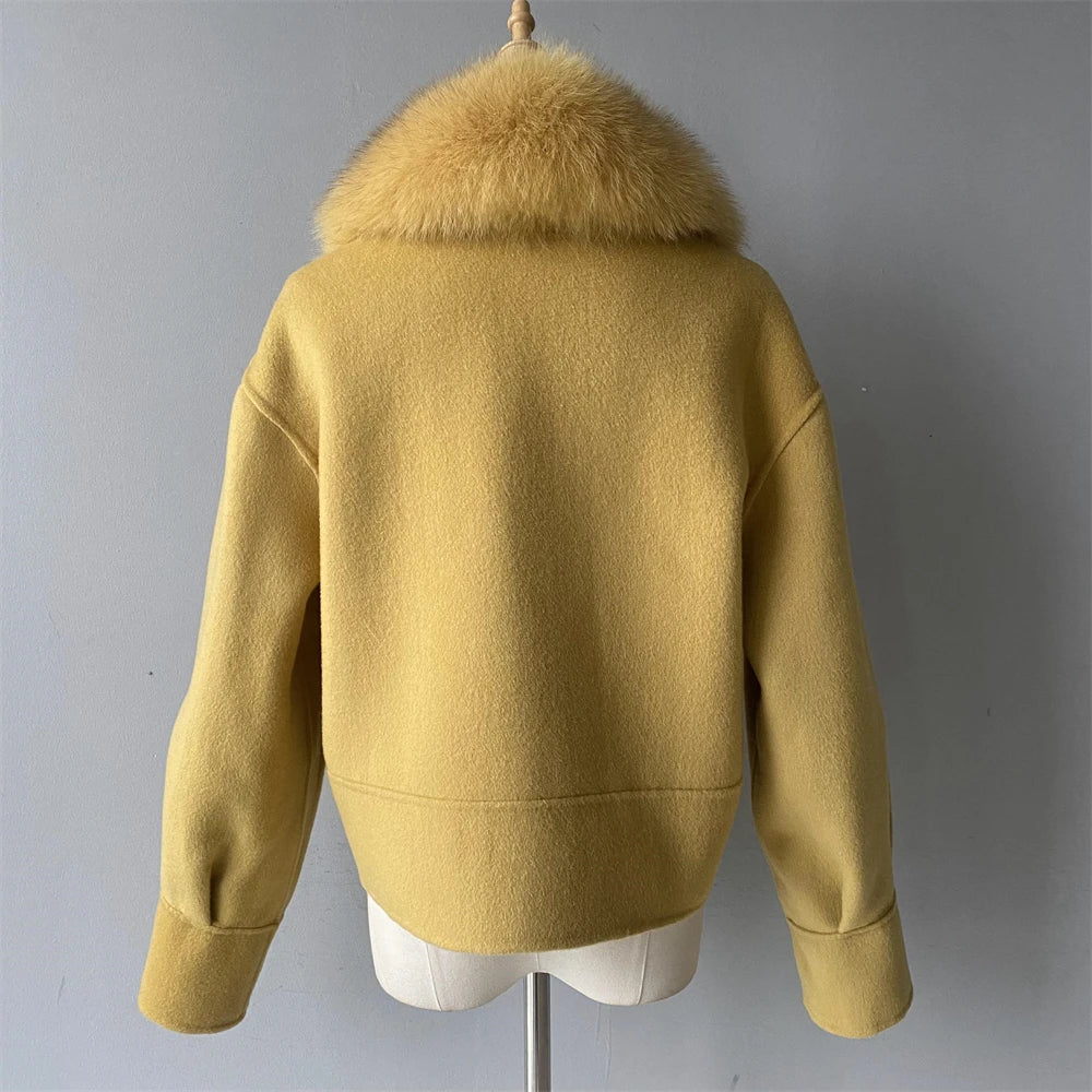 Yellow jacket with fur collar on a mannequin against a gray background