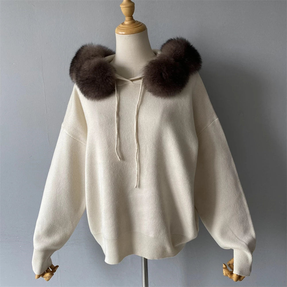 Beige sweater with brown fur collar on a mannequin against a gray background