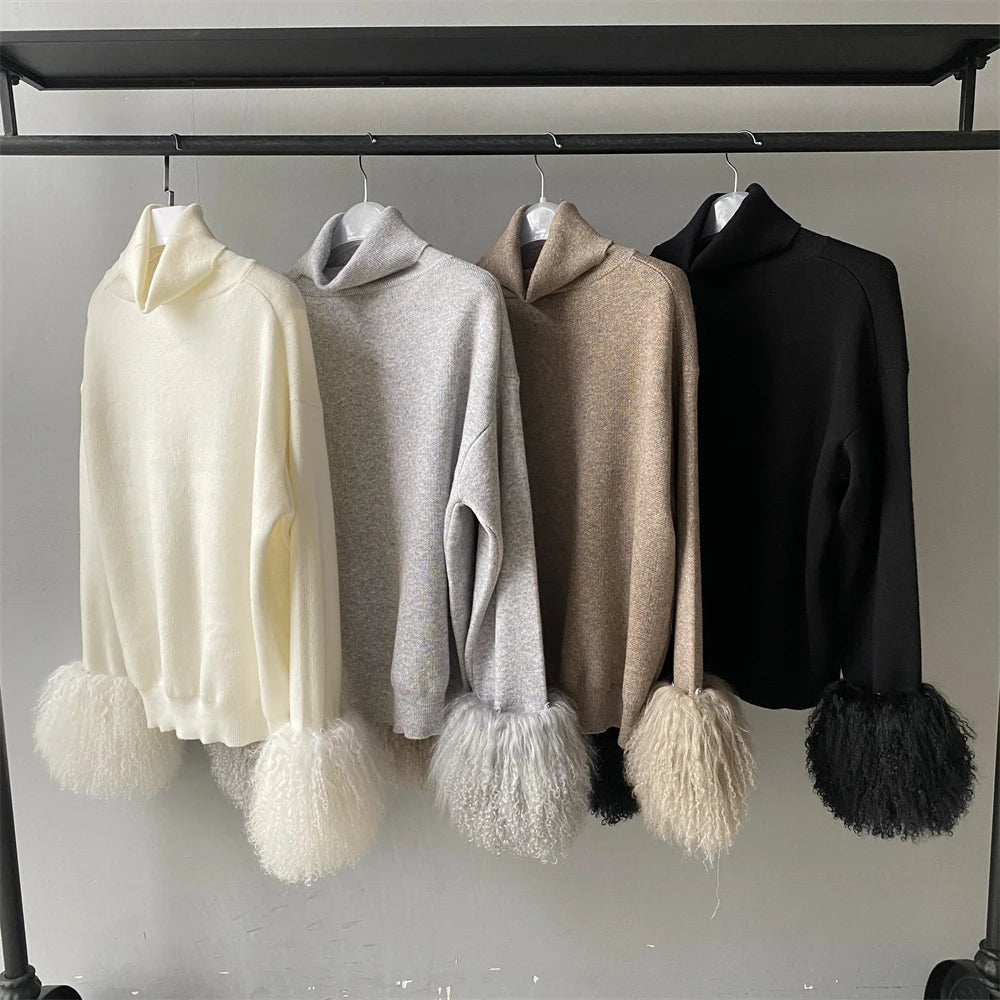 Four hoodies with pom-pom details hanging on a rack against a neutral background
