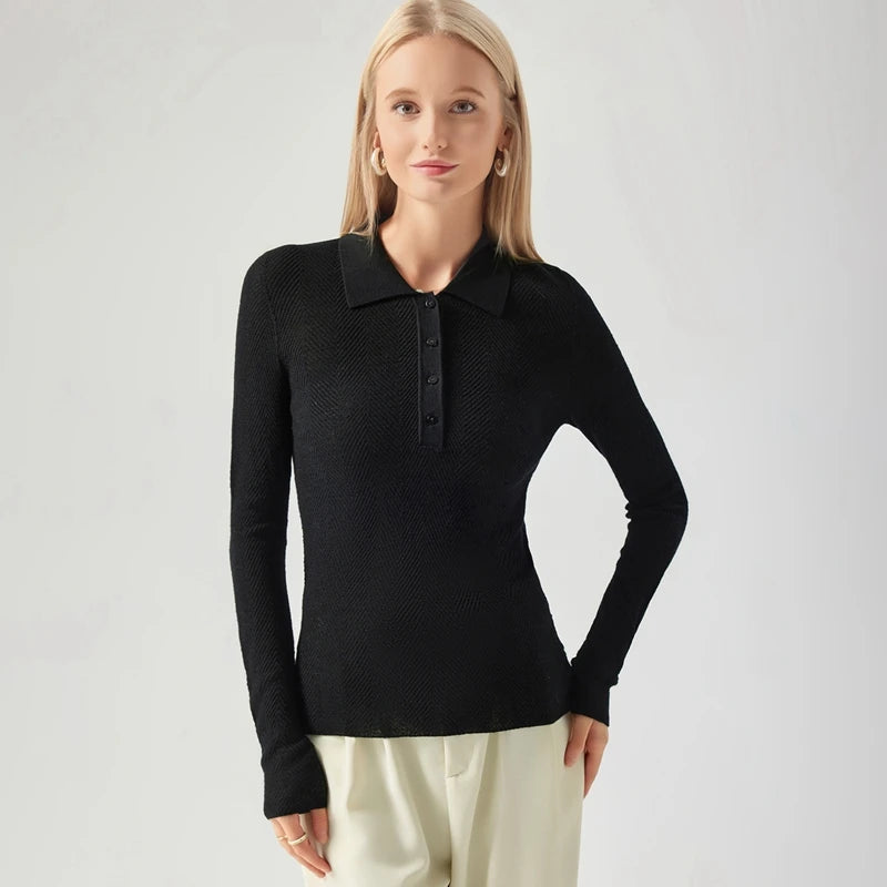 Woman wearing a black long-sleeve polo shirt on a light gray background