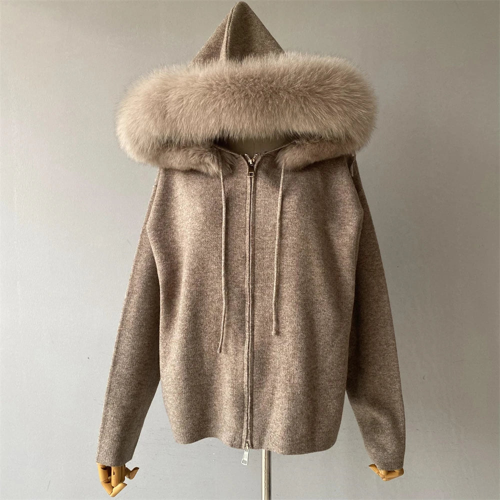 Beige hooded jacket with fur trim on a mannequin against a plain background