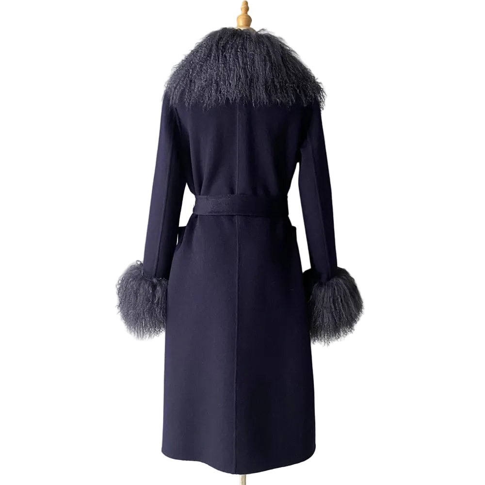 Navy blue coat with fur trim on a mannequin against a plain background
