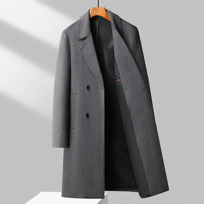 Gray overcoat on a wooden hanger against a light gray background