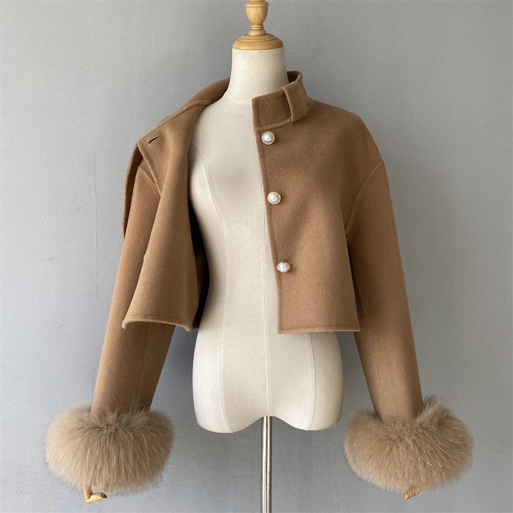 Brown jacket with fur cuffs on a mannequin against a gray background